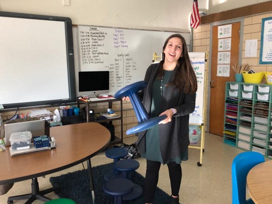 Belle Morris’ Teacher of the Year Caitlin Hatfield laughs as she shows off a “wobble stool,” part of the flexible seating in her open classroom. She says the stool allows the students to burn off energy while they’re doing their work. “It’s not distracting,” she says – actually quite the opposite. January 22, 2020.