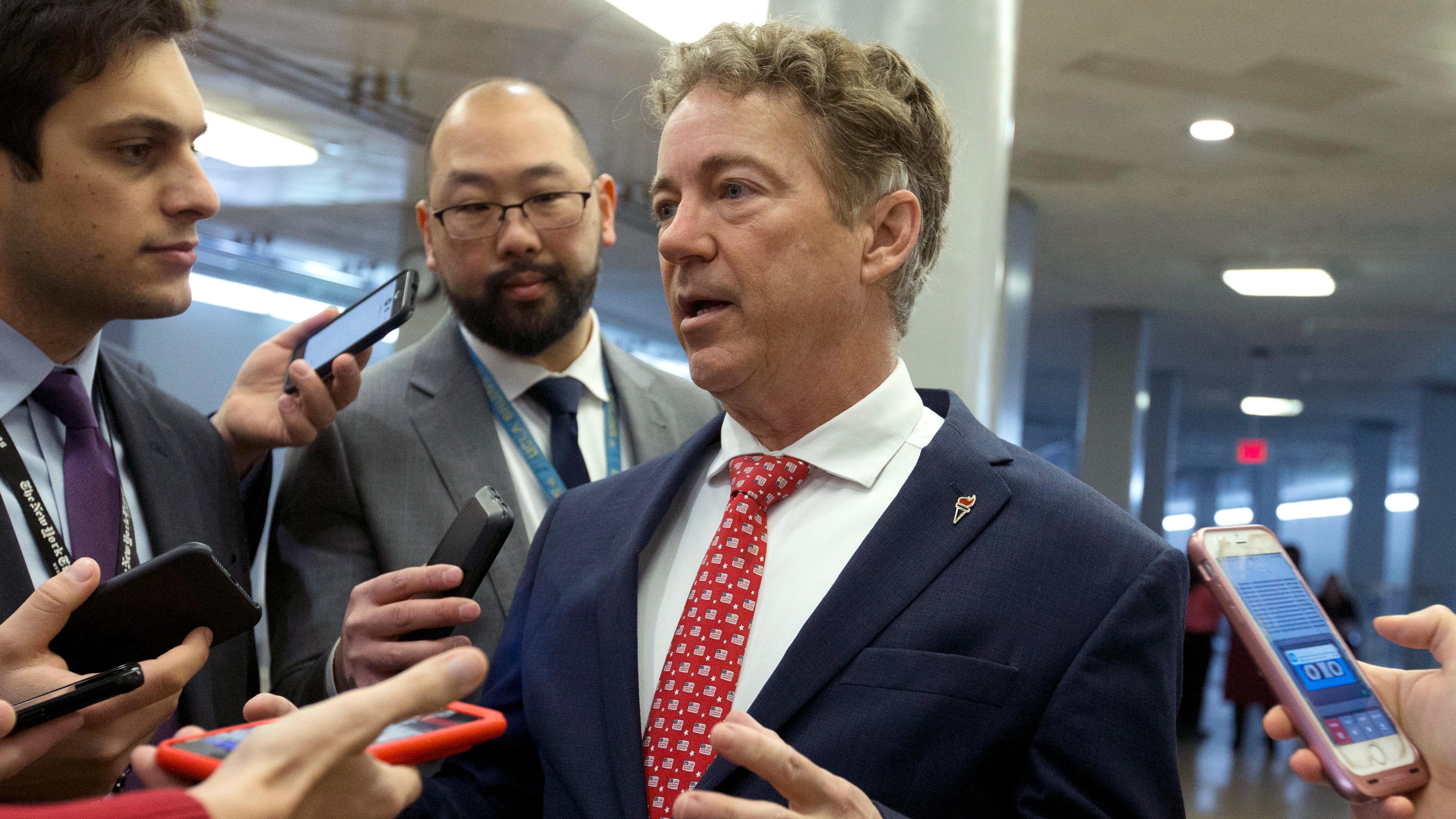 Rand Paul works on crossword puzzle during Trump impeachment trial