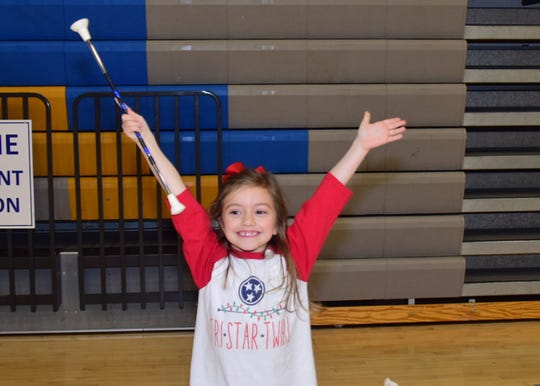 AnnaJo Ibbotson, 5, strikes a pose at the majorette workshop held at Karns High School Monday, Jan. 20.