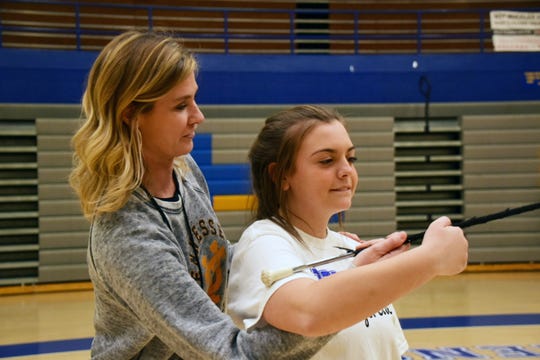 Instructional coach Karyn Lee helps Belle Whitson, 15, with follow through at the majorette workshop held at Karns High School Monday, Jan. 20.