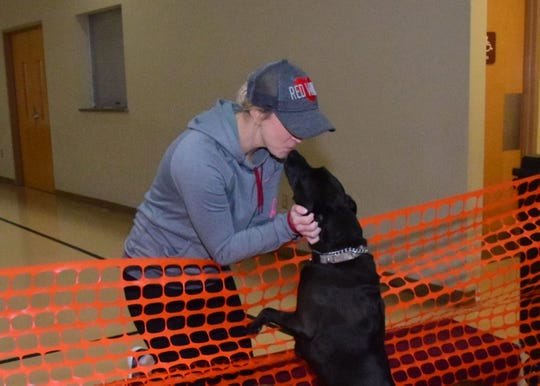 Rocky the Lab mix gives his owner Katy Ramey a kiss at the second annual Paw Party held at West Towne Christian Church Saturday, Jan. 18.