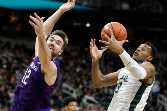 Michigan State forward Xavier Tillman (23) catches the inbound pass intended for Northwestern guard Pat Spencer (12).