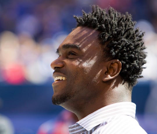 Edgerrin James smiles as he watches video highlights of his career, before being inducted into the Ring of Honor for the Indianapolis Colts at Lucas Oil Stadium in 2012.