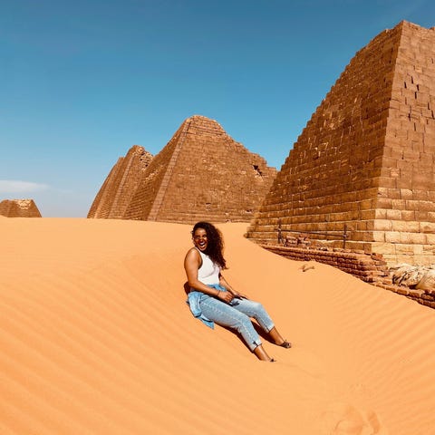 USA TODAY reporter sits next to the Pyramids in Me