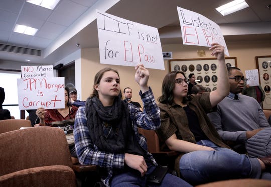 Emma Moshaver, left, and Isabella Soto protest the pending sale of El Paso Electric during the Feb. 4 City Council meeting.