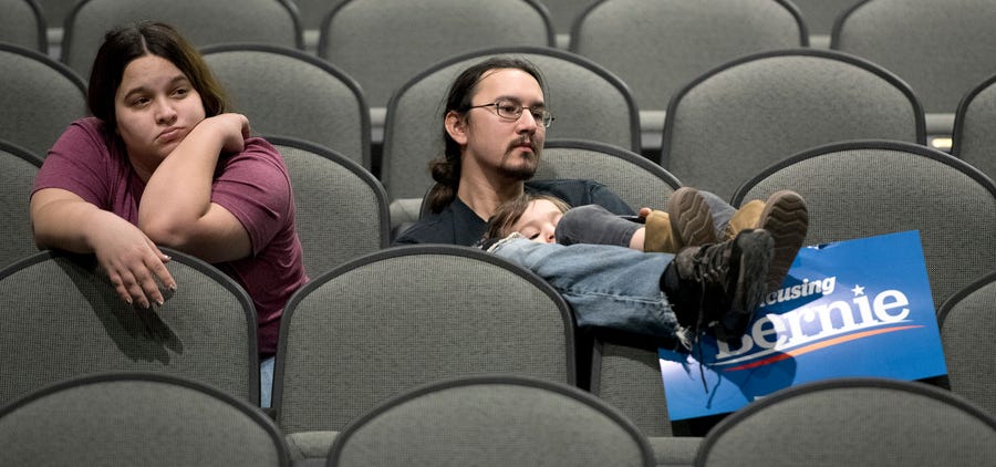 Jeff Lopez holds his son, Tristan, 4, as they and Jeff's wife, Jessika, sit in an area for Bernie Sanders supporters during the Woodbury County Third Precinct Democratic caucus, Monday, Feb. 3, 2020, at West High School in Sioux City, Iowa. Iowans across the state attended Democratic and Republican caucuses Monday.