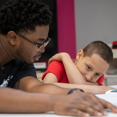 Professional mentor Rakim Isaacs, left, assists La