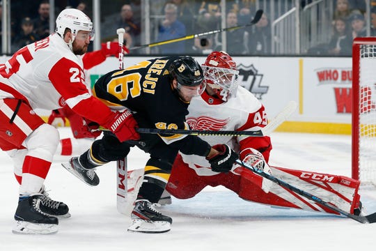 Boston Bruins' David Krejci (46) chases the puck after his shot was blocked by Detroit Red Wings' Jonathan Bernier (45) during the second period.