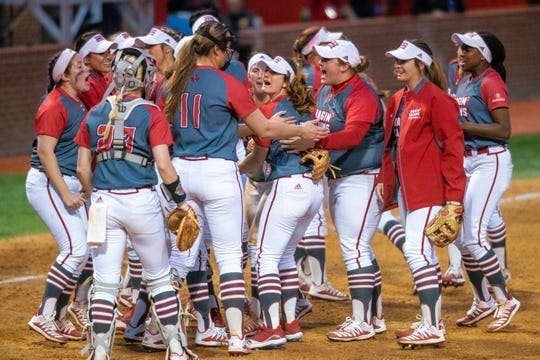 UL's softball team congratulates Kaitlyn Alderink after her impressive catch as the Ragin' Cajuns take on the LSU Tigers at Yvette Girouard Field on Saturday, Feb. 15, 2020.