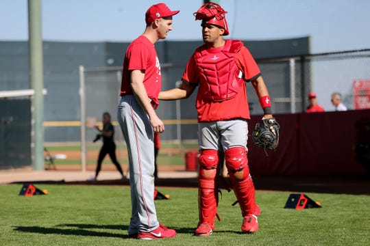 Cincinnati Reds non-roster invitee pitcher Nate Jones (57) talks with non-roster invitee catcher Francisco Pena (75) during a bullpen session, Monday, Feb. 17, 2020, at the baseball team's spring training facility in Goodyear, Ariz. 