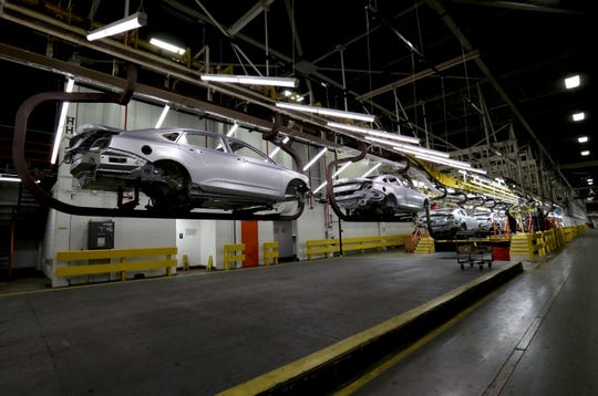 A 2020 Chevrolet Impala still yet to be painted is moved on a hoist on the production line on Thursday, February 20, 2020 at the GM Detroit-Hamtramck Assembly plant. The car is nearing its end of production as the plant is being retooled and fitted for electric vehicles. 