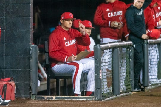 Ragin' Cajuns pitching coach B.J. Ryan, a former MLB All-Star, signals in a call from the dugout during UL's 9-6 loss to Tulane on Wednesday night at The Tigue.
