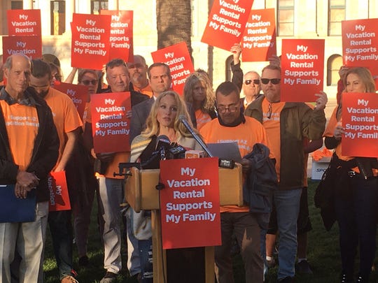 Phoenix resident Sarah Carlblom (center) speaks to a rally for owners of vacation rentals at the Arizona Capitol on Feb. 20, 2020.