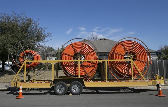 Contractors for internet provider Google Fiber work in Southeast Austin off East William Cannon Drive in 2016.