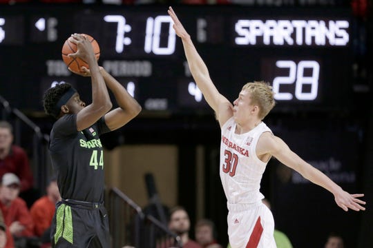 Michigan State's Gabe Brown (44) shoots against Nebraska's Charlie Easley (30) during the first half.