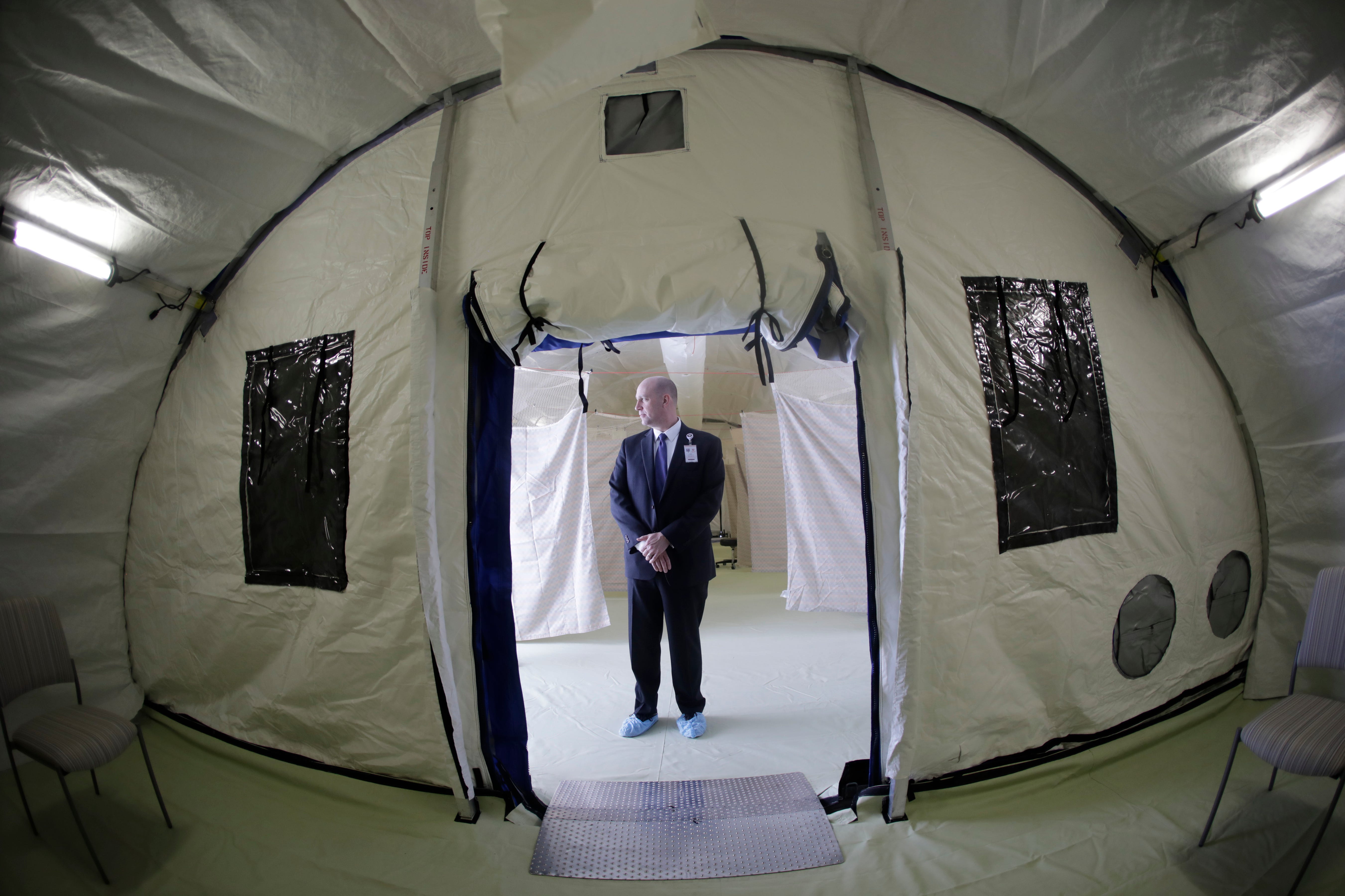 Philip Chaffee, senior director emergency management stands in a negative pressure tent outside the University of Utah's hospital, Monday, March 9, 2020, in Salt Lake City. The hospital is taking steps to limit the spread of the new coronavirus, including new visitor policies and the construction of outdoor negative pressure tents where people can be tested without having to go inside the hospital building.
