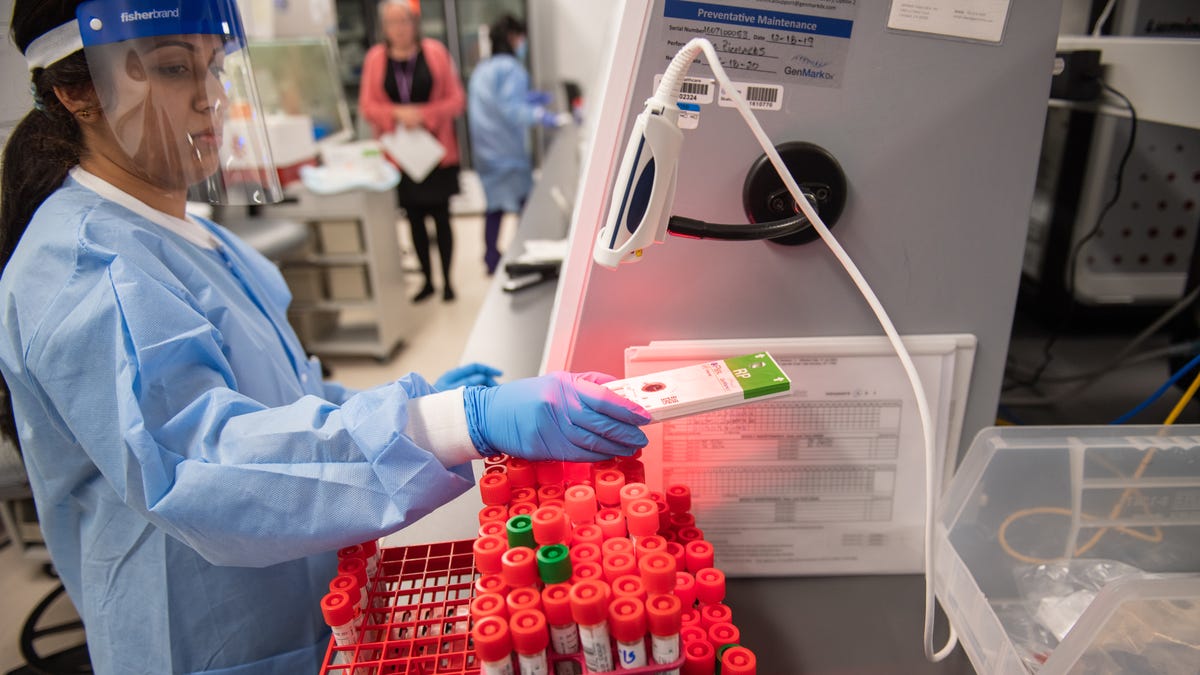 A lab technician begins semi-automated testing for COVID-19 in Lake Success, New York, on March 11, 2020.