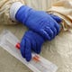 A nurse holds a swabs-and-test-tube kit to test people for COVID-19, the disease that is caused by the novel coronavirus, at a drive-thru station set up in the parking lot of the Beaumont Hospital in Royal Oak, Michigan, on March 16, 2020.
