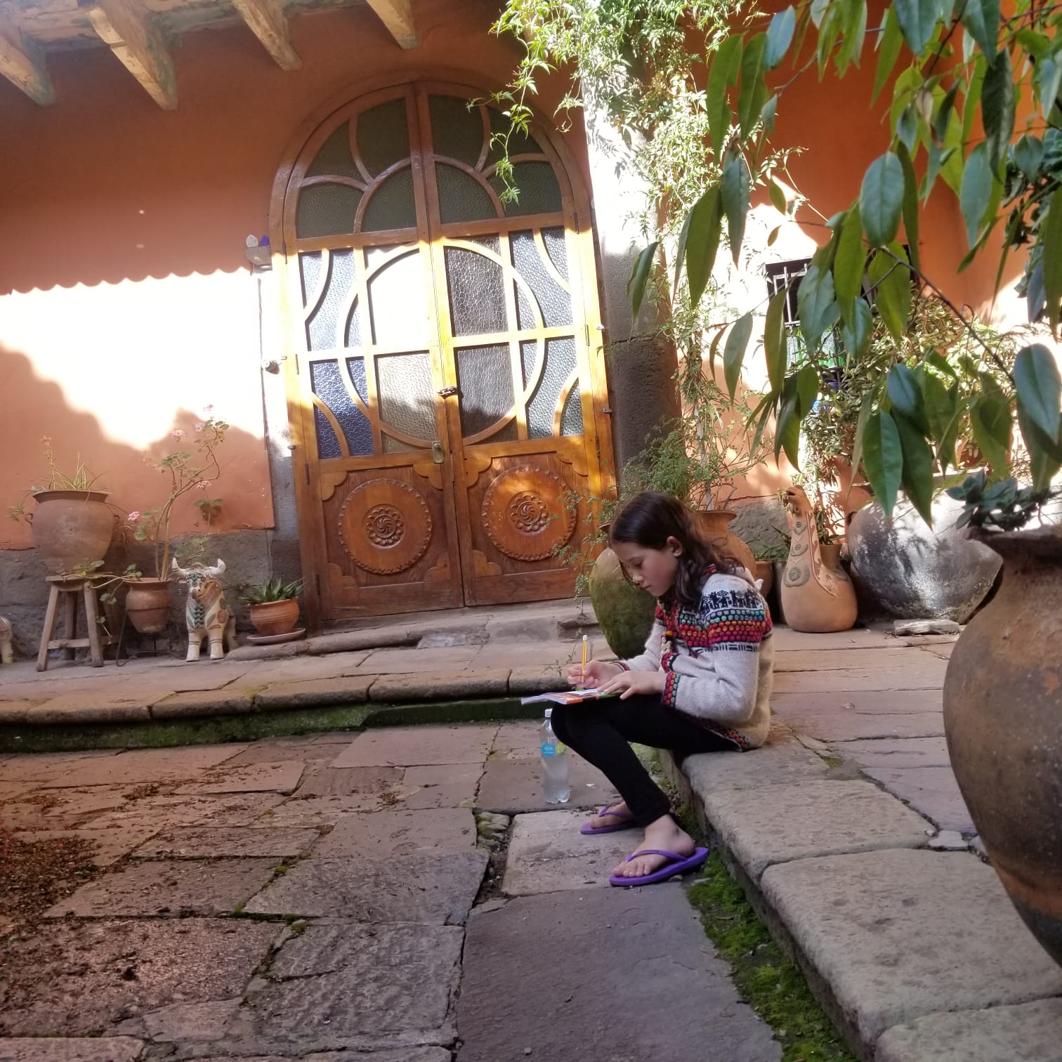 Anya Bailey, 8, has started journaling her experience during the lockdown in Peru, mom Stephanie said. She is pictured in the courtyard of the Airbnb where the family is staying.