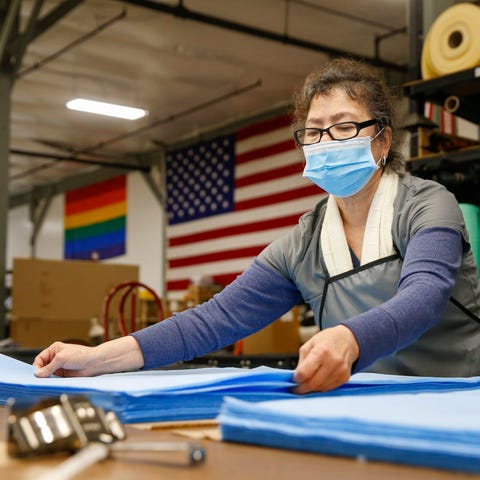 Edelmira Martinez prepares fabric for cutting into