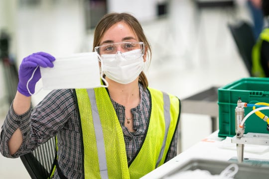 Engineers and technicians set up and test the machines that will be used to manufacture Level 1 face masks Monday at the General Motors Warren manufacturing facility. Production will begin next week and within two weeks ramp up to 50,000 masks per day, with the potential to increase to 100,000 per day. (Photo by John F. Martin for General Motors)