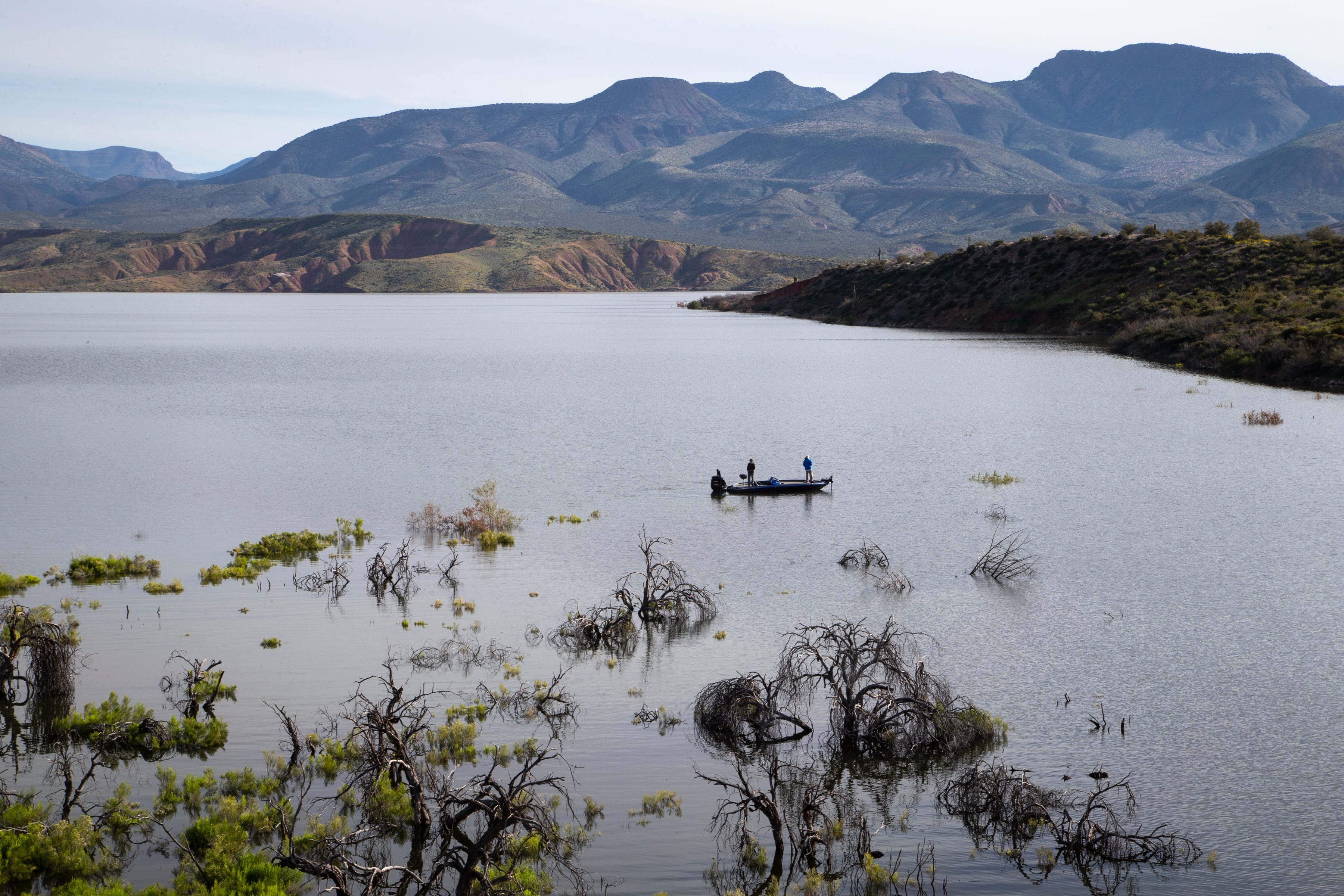 A couple fish from their boat at Roosevelt Lake on March 31. A wet winter has filled reservoirs managed by Salt River Project. They now sit 98% full, their highest level since 2010.