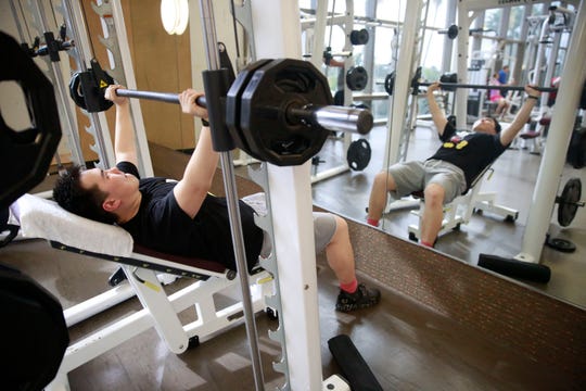 In this March 10, 2020, file photo, Darren Chen lifts weights at Life Time Athletic gym in Boca Raton, Fla.