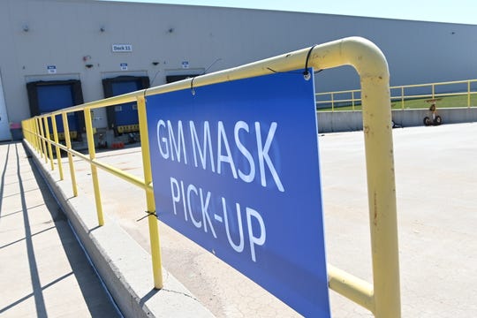 A sign at GM's formerly idled Warren Transmission plant signals the pickup area for face masks for hospitals.