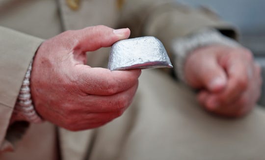 Kurt Koehler holds a pod of aluminum alloy, that by adding water it causes it to react and become hydrogen. The hydrogen is used to fuel the engine.