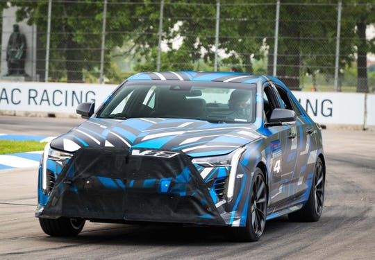 GM VP for Global Product Ken Morris drives the blue CT4 performance variant around Belle Isle in 2019. In production trim, the car will be called the CT4-V Blackwing.