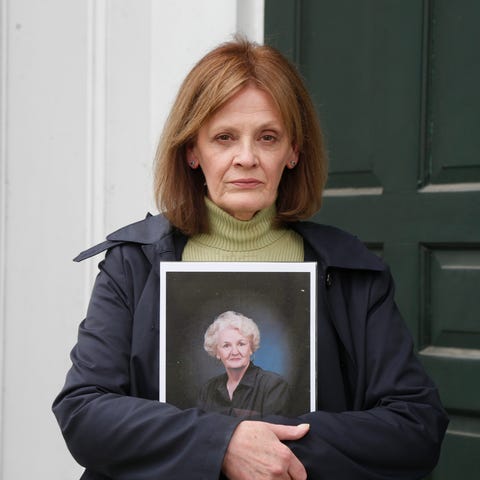 Kathleen Cole holds a portrait of her mother Dolor