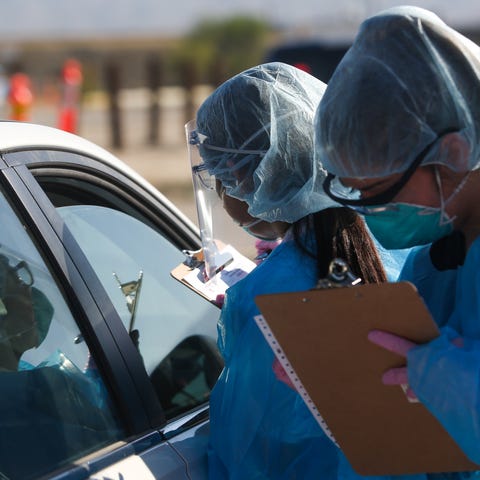 Health care workers conduct LabCorp PCR COVID-19 t