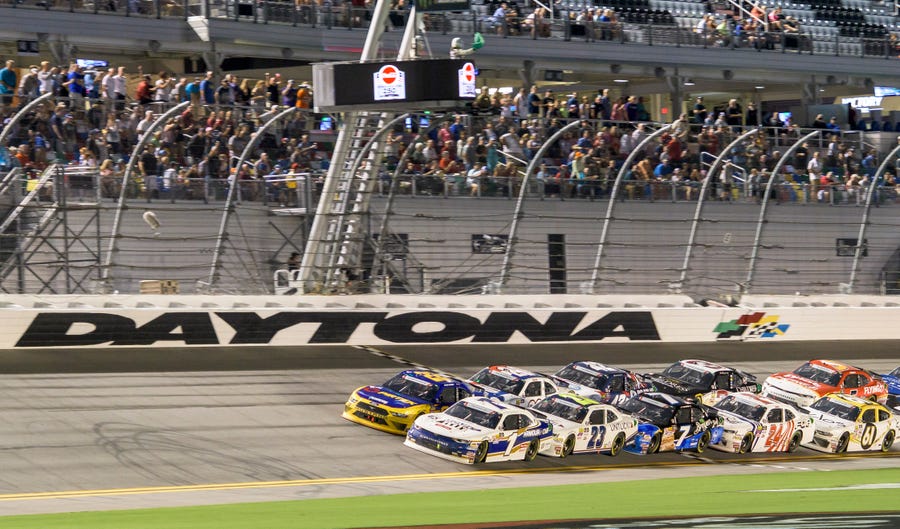 Elliott Sadler (1) leads the pack as racing is restarted in overtime at the 2018 Coca-Cola Firecracker 250 at Daytona International Speedway in Daytona Beach on Friday, July 6, 2018.