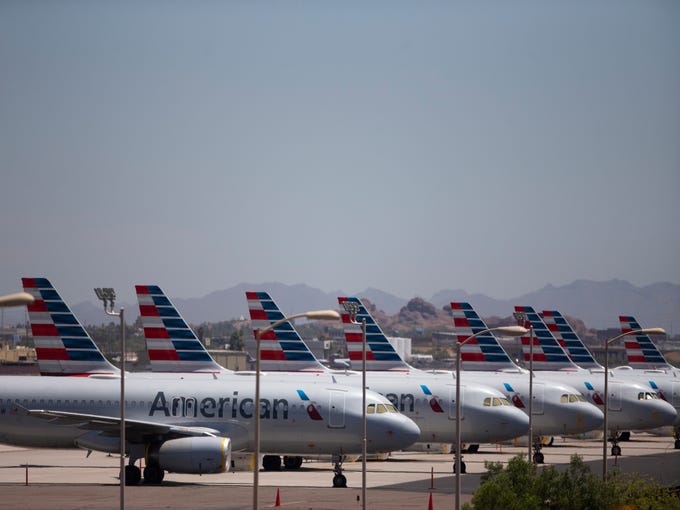 Jets sit parked near the run way at Phoenix Sky Harbor International Airport on May 7, 2020. 