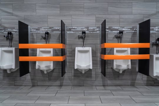 Sinks and urinals are blocked off to make sure of social distancing for employees during an open house tour for workers as employees learn about the new precautions set in place as they prepare to return to work at Lear Corporation in Flint on Thursday, May 14, 2020.