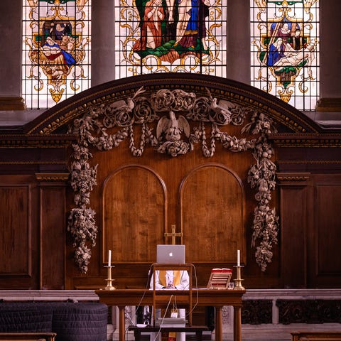 A reverend delivers a service via webcam in London