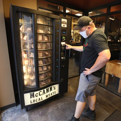 Kevin McCann tests out the new meat vending machin