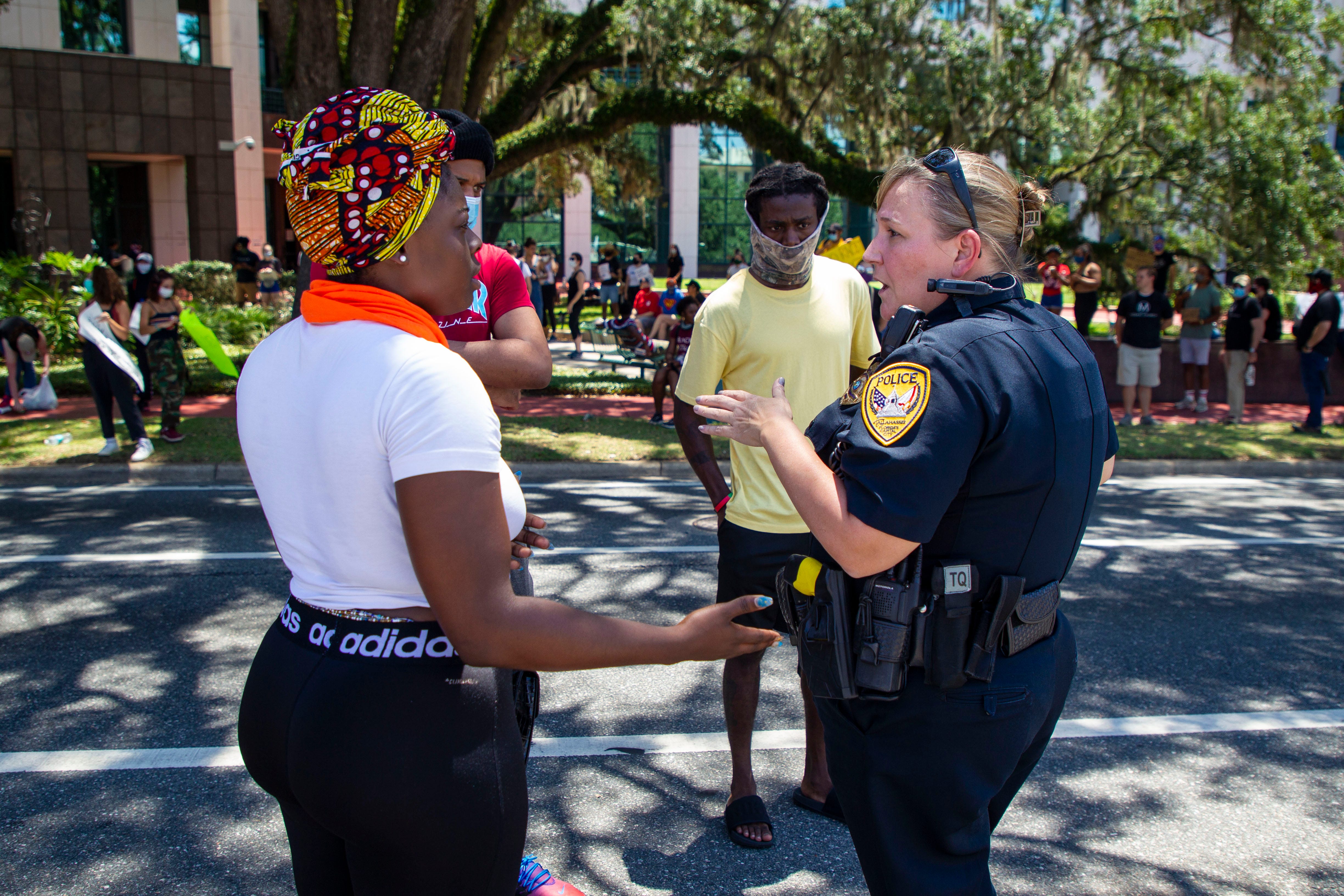 Protest organizers speak with an officer from the Tallahassee Police Department as they work to continue a peaceful protest outside the Leon County Courthouse on Sunday afternoon, May 31, 2020. The crowd of protesters demand to speak with Tallahassee Chief of Police Lawrence Revell and State Attorney Jack Campbell in regards to the recent officer involved shootings. 