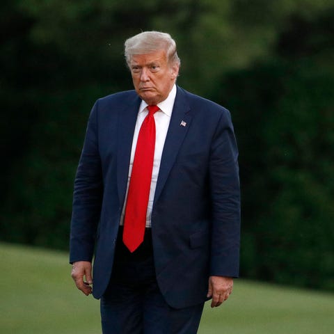 President Donald Trump walks on the South Lawn of 