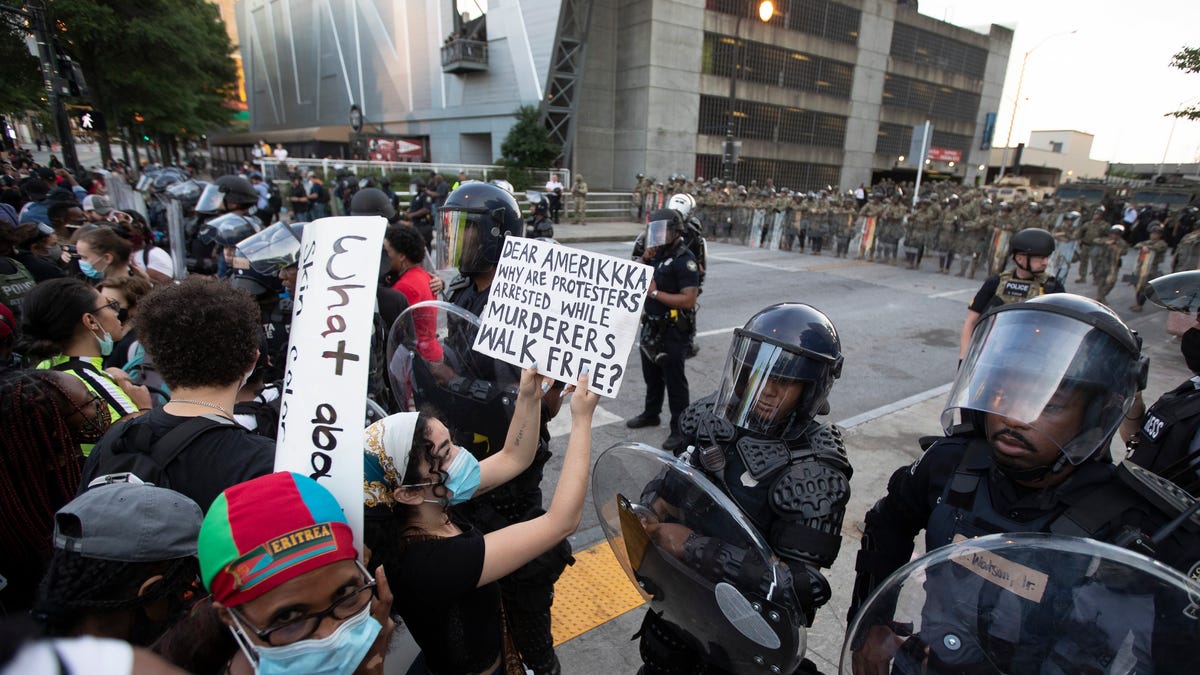 A protester confronts Atlanta police during a demonstration Monday, June 1, 2020, in Atlanta over the death of George Floyd, who died May 25 after being restrained by Minneapolis police.