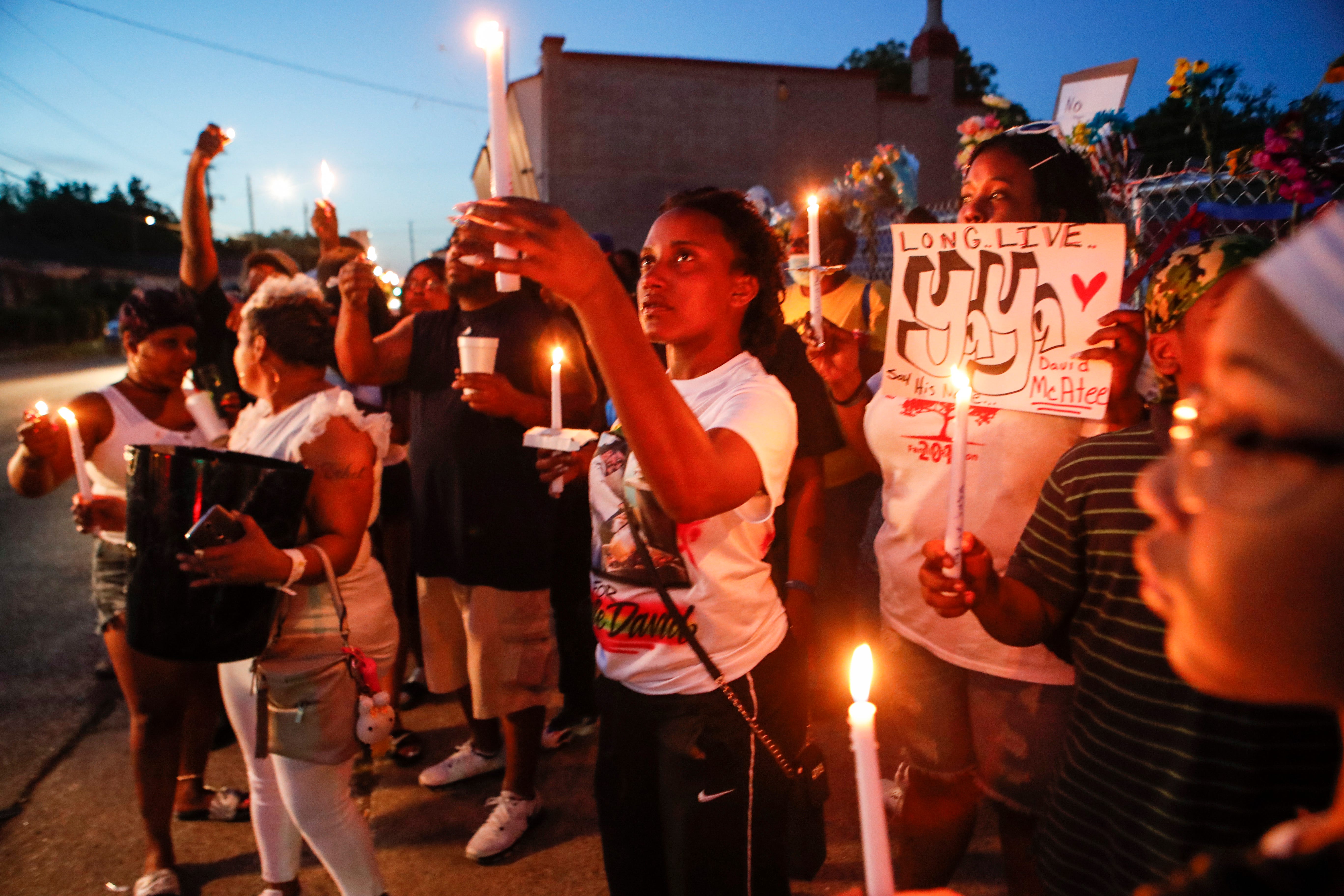 Family and friends of David McAtee, who was fatally shot by Kentucky National Guard members, hold a vigil in Louisville on June, 2, 2020.