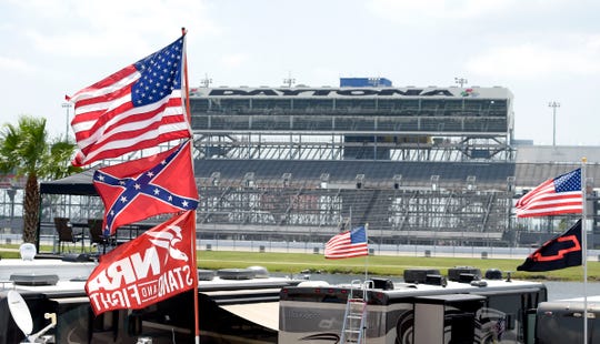 Confederate and American flags fly on top of a motor home at Daytona International Speedway in 2015.