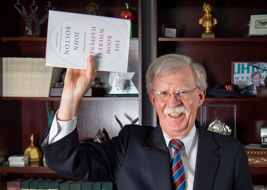 Ambassador John Bolton mimics photos of President Trump holding a bible.