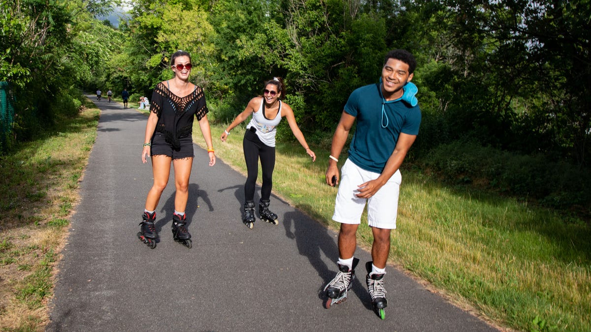 Alanna Conklin, left, Hannah Latorre, center, and Brandon Turner, rollerblade on the Heritage Trail in Chester on June 19.