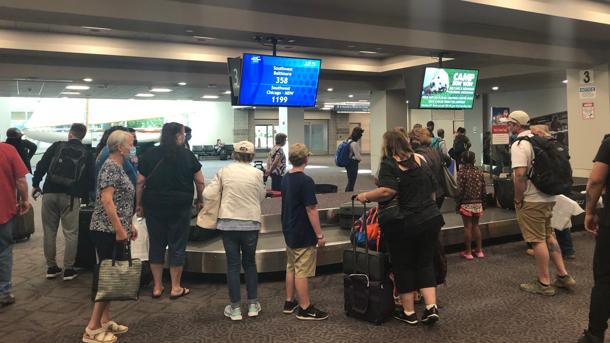 The Southwest Airlines baggage claim carousel at TF Green International Airport in Providence, Rhode Island, was crowded on a summer Saturday despite social distancing recommendations during the coronavirus pandemic.