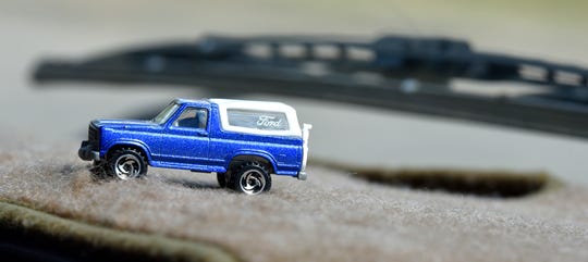 A toy Bronco on the carpeted dash of the full-size Bronco owned by Shanna Gibson.