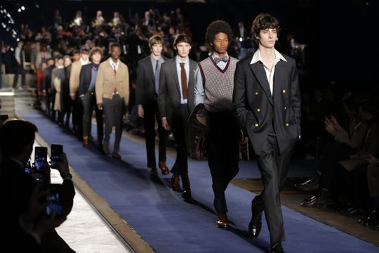 Models showcase suits during a Brooks Brothers fashion show in Italy in 2018.