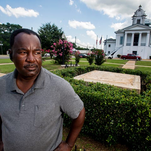 Lowndes County Commissioner Robert Harris stands n