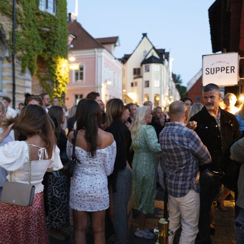 People outside a restaurant without masks or socia