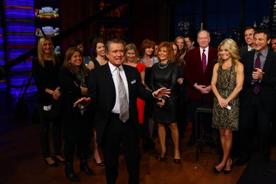 Regis Philbin, center, and Kelly Ripa, right, on the set during Philbin's final show of "Live! With Regis and Kelly" on Nov. 18, 2011, in New York.